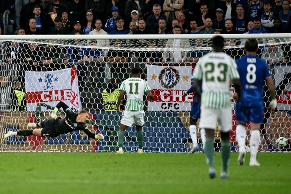 Real Betis' Moroccan forward #10 Abde Ezzalzouli (not pictured) scores his team's first goal past Chelsea's Swedish-Danish goalkeeper #12 Filip Jorgensen (L) during the UEFA Conference League final football match between Real Betis and Chelsea FC in Wroclaw on May 28, 2025. Sergei GAPON / AFP