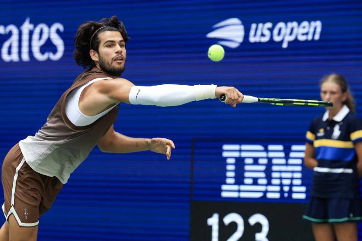 Spain's Carlos Alcaraz reaches to hit a return to China's Wu Yibing during their men's singles third round tennis match on day six of the US Open tennis tournament at the USTA Billie Jean King National Tennis Center in New York City on September 4, 2026. TIMOTHY A. CLARY / AFP
