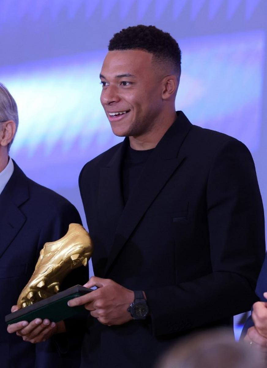 Real Madrid's French forward Kylian Mbappe smiles after receiving the 2024-25 European Golden Shoe award honoring the year's leading goalscorer during a ceremony at Santiago Bernabeu Stadium in Madrid on October 31, 2024. Oscar DEL POZO / AFP