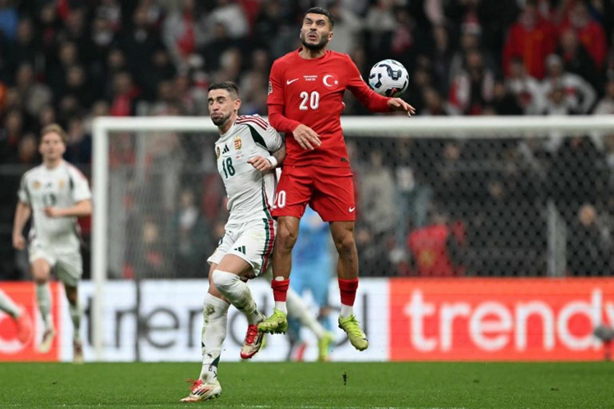 Hungary's midfielder #18 Zsolt Nagy and Turkey's forward #20 Oguz Aydin jump for the ball during the UEFA Nations League playoff first-leg football match between Turkey and Hungary at the Rams Park Ali Samiyen Sport Complex Stadium in Istanbul on March 20, 2025. OZAN KOSE / AFP