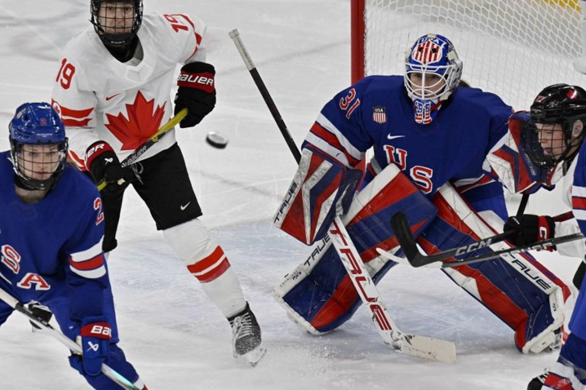 (From L) USA's #02 Lee Stecklein, Canada's #19 Brianne Jenner, and USA's #31 Aerin Frankel vie for the puck during the women's gold medal ice hockey match between USA and Canada at the Milano Santagiulia Ice Hockey Arena during the Milano Cortina 2026 Winter Olympic Games in Milan, on February 19, 2026. Alexander NEMENOV / AFP