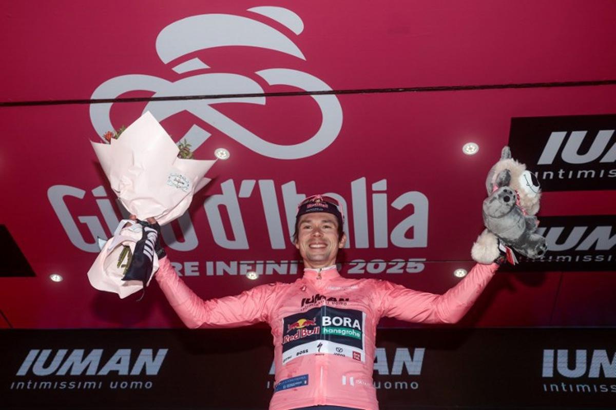 Red Bull-Bora-Hansgrohe's Slovenian rider Primoz Roglic wearing the overall leader's pink jersey (Maglia Rosa) poses on the podium after the second stage of the 108th Giro d'Italia cycling race, a 13.7km individual time-trial from Tirana to Tirana in Albania, on May 10, 2025. Luca Bettini / AFP