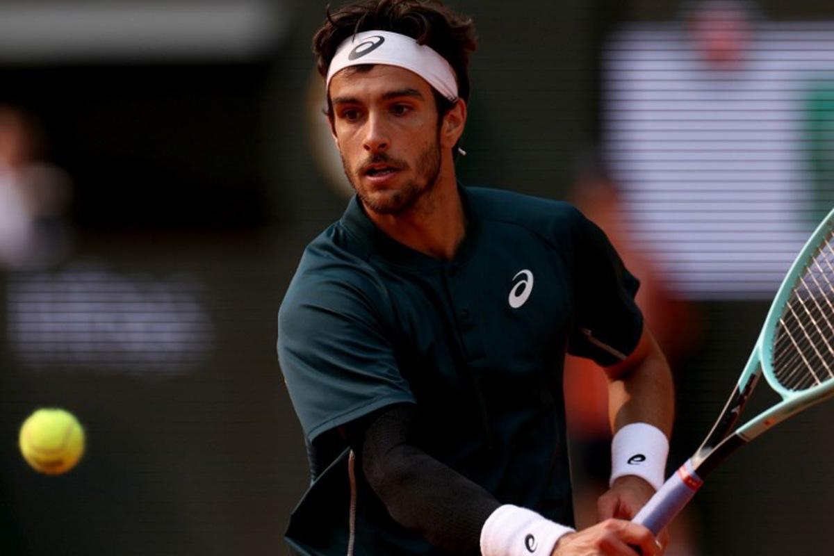 Italy's Lorenzo Musetti plays a backhand return to US Frances Tiafoe during their men's singles quarter-final match on day 10 of the French Open tennis tournament on Court Philippe-Chatrier at the Roland-Garros Complex in Paris on June 3, 2025. ALAIN JOCARD / AFP