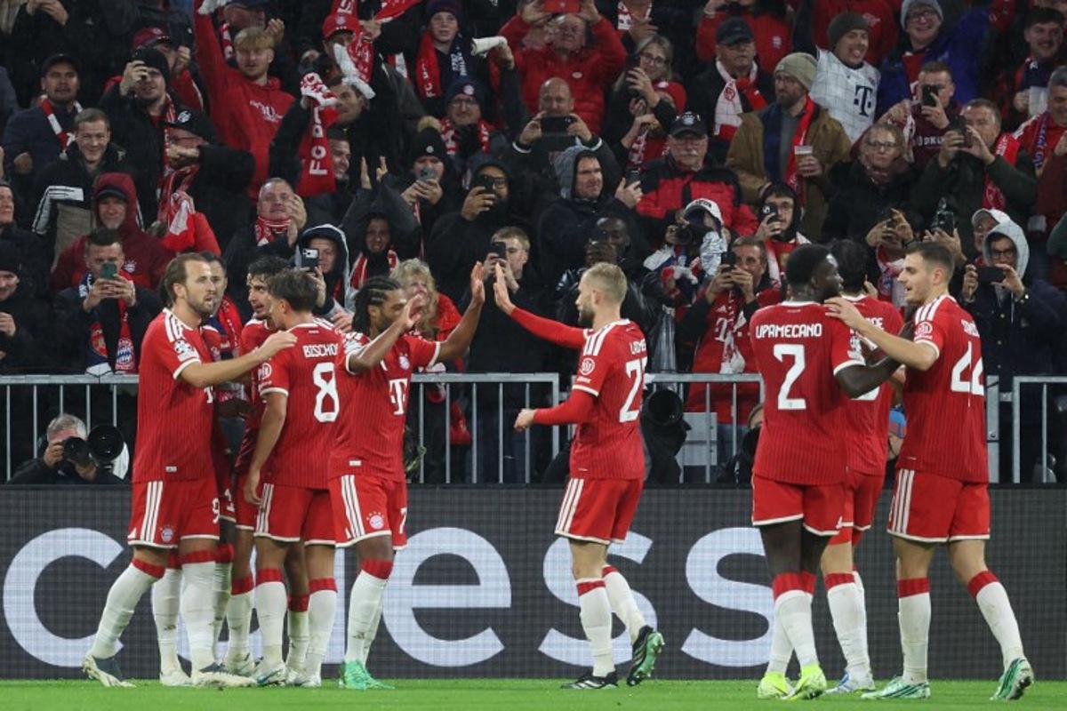 Bayern Munich's Canadian defender #19 Alphonso Davies (hidden) celebrates scoring the 1-1 goal with his teammates during the UEFA Champions League football match between FC Bayern Munich and Arsenal FC in Munich, southern Germany on October 21, 2026. Karl-Josef HILDENBRAND / AFP