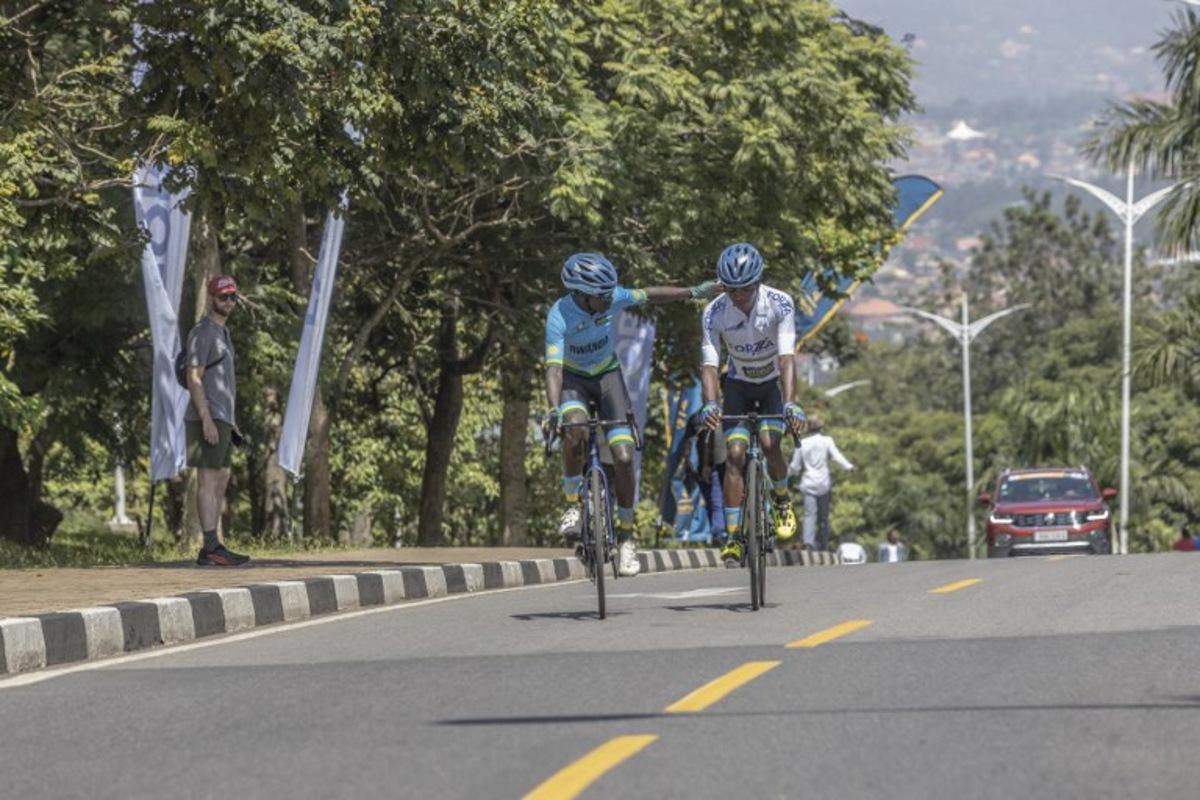 Rwanda National Team's Rwandan rider Samuel Niyonkuru (L) and Rwanda National Team's Rwandan rider Eric Manizabayo (R) interact together before the beginning of the final stage of the 16h Tour du Rwanda on 25 February 2024, in Kigali. Israel Premier Tech's British rider Joseph Blackmore, won the Tour of Rwanda which ended on Sunday in the capital Kigali. Guillem Sartorio / AFP