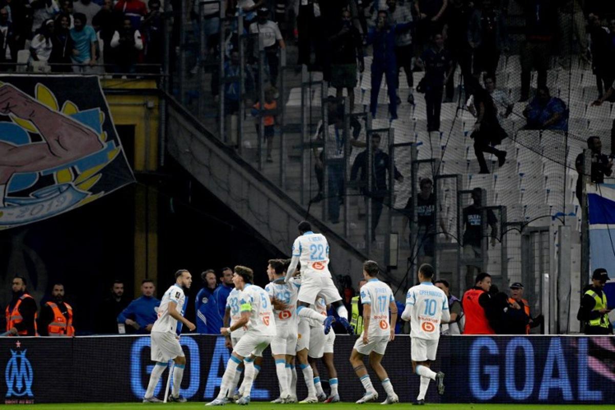 Marseille's players celebrate after scoring their first goal during the French L1 football match between Olympique de Marseille (OM) and Paris Saint-Germain (PSG) at the Velodrome stadium in Marseille on September 22, 2025. Miguel MEDINA / AFP