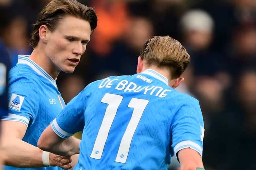 Napoli's Scottish midfielder #08 Scott McTominay celebrates with Napoli's Belgian midfielder #11 Kevin De Bruyne after scoring a goal during the Italian Serie A football match between Parma Calcio 1913 and SSC Napoli at the Ennio Tardini Stadium in Parma on April 12, 2026. MARCO BERTORELLO / AFP