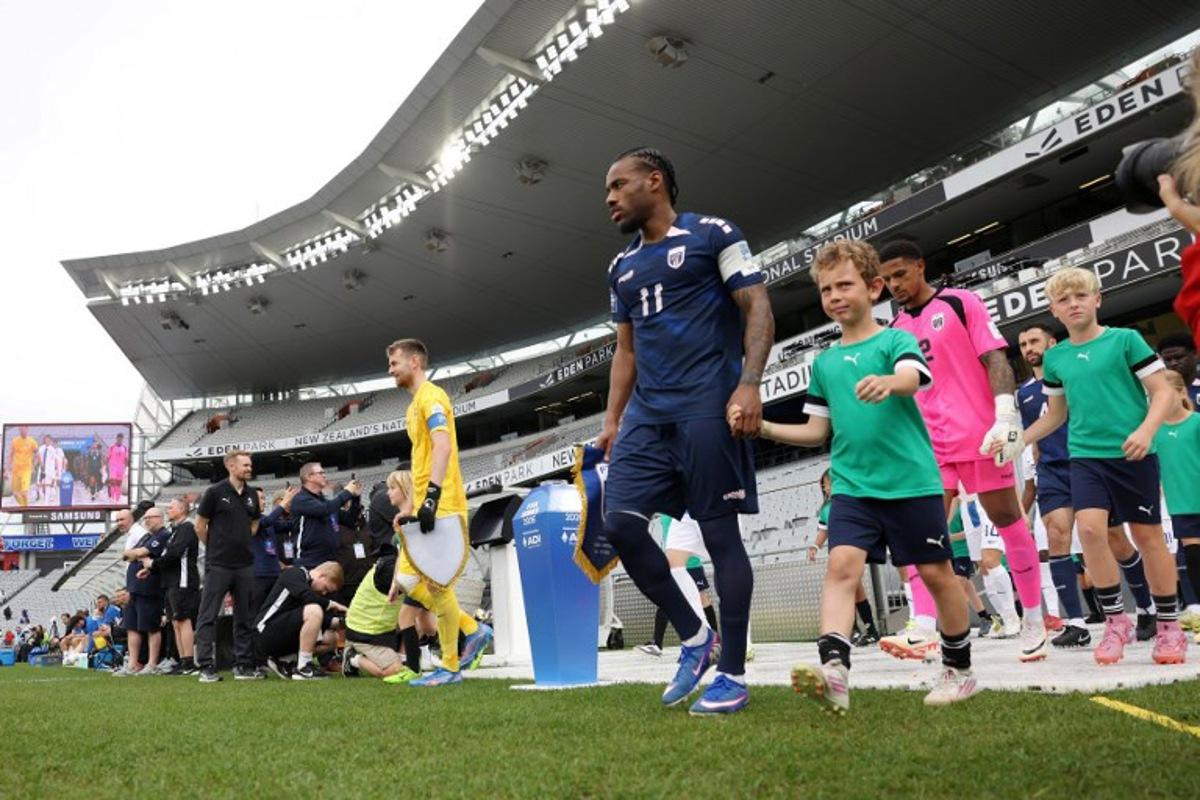 Cape Verde's Garry Rodrigues (R) leads his team out during the international friendly football match between Cape Verde and Finland at Eden Park in Auckland on March 30, 2026. Michael Bradley / AFP