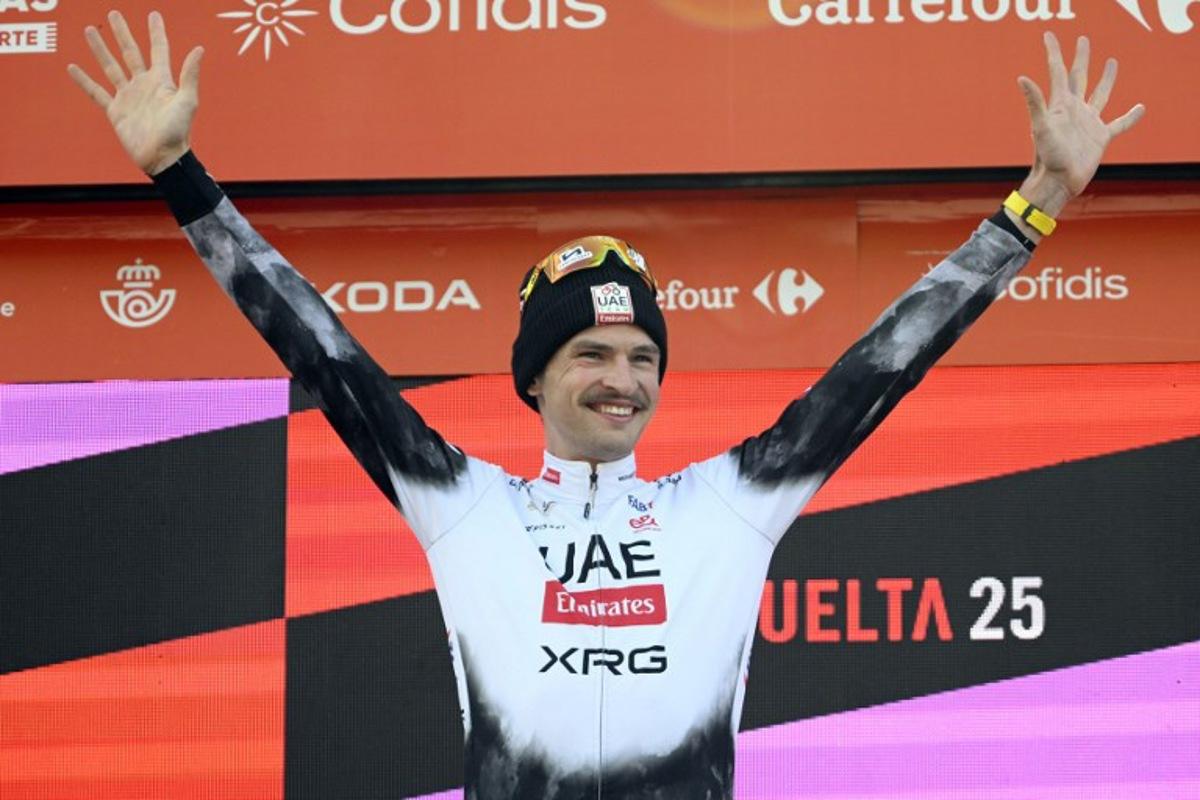Team UAE's Australian rider Jay Vine celebrates on the podium after winning the sixth stage of La Vuelta a Espana cycling tour, a 170 km race between Olot and Pal, in Andorra, on August 28, 2025. Josep LAGO / AFP
