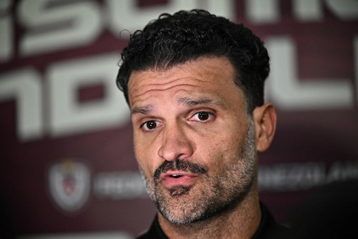 Venezuela's football head coach Oswaldo Vizcarrondo speaks with the press after an act to welcome the Venezuelan national football team that qualified for the U-17 World Cup Qatar-2025, in Caracas on April 14, 2025. Federico PARRA / AFP