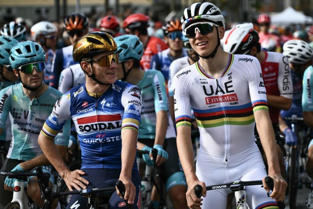 Soudal Quick-Step team's Belgian rider Remco Evenepoel (L) speaks with UAE Team Emirates team's Slovenian rider Tadej Pogacar (R) before the start of 118th edition of the Giro di Lombardia (Tour of Lombardy), a 252km cycling race from Bergamo to Como on October 12, 2024. Marco BERTORELLO / AFP