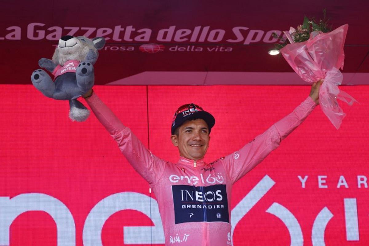 Overall leader Team Ineos' Ecuadorian rider Richard Carapaz celebrates on the podium after the 19th stage of the Giro d'Italia 2022 cycling race, 178 kilometers from Marano Lagunare to Santuario di Castelmonte, northeastern Italy, on May 27, 2022. Luca Bettini / AFP