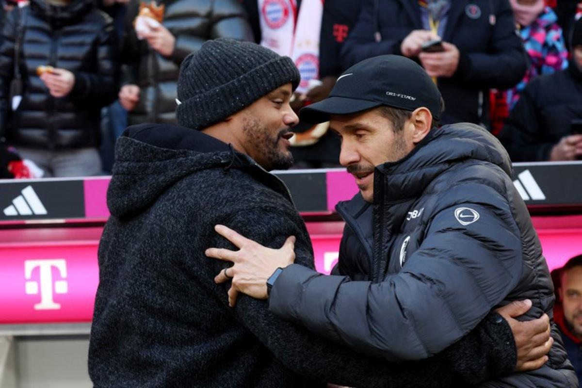 Bayern Munich's Belgian head coach Vincent Kompany (L) greets Freiburg's German head coach Julian Schuster prior to the German first division Bundesliga football match between FC Bayern Munich and SC Freiburg in Munich, southern Germany on November 22, 2025. Karl-Josef HILDENBRAND / AFP