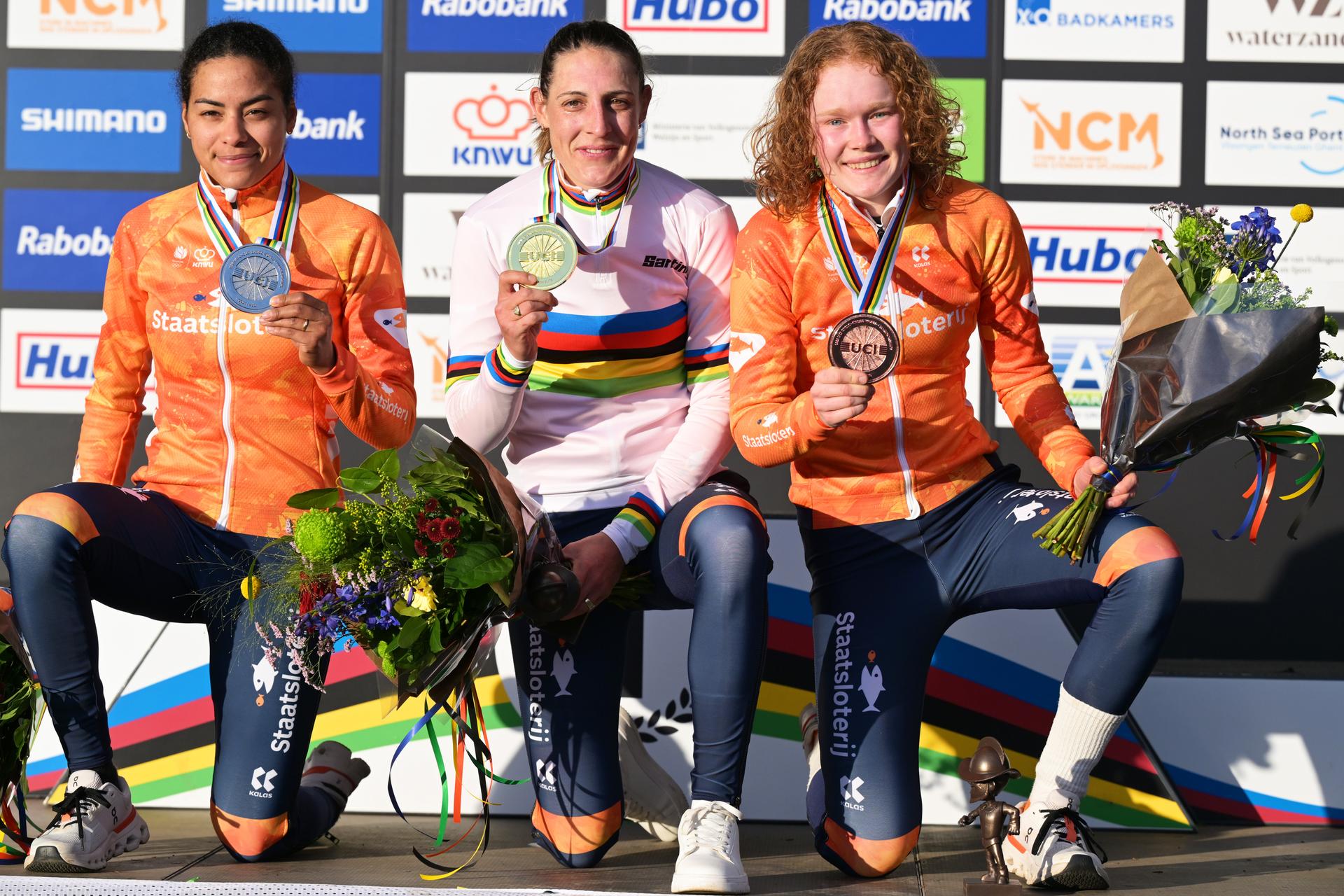 L-R, silver medalist Dutch Ceylin del Carmen Alvarado, winner world champion Dutch Lucinda Brand and bronze medalist Dutch Puck Pieterse celebrate on the podium of the elite women race at the UCI Cyclocross World Championships, on Saturday 31 January 2026, in Hulst, The Netherlands. BELGA PHOTO DAVID PINTENS