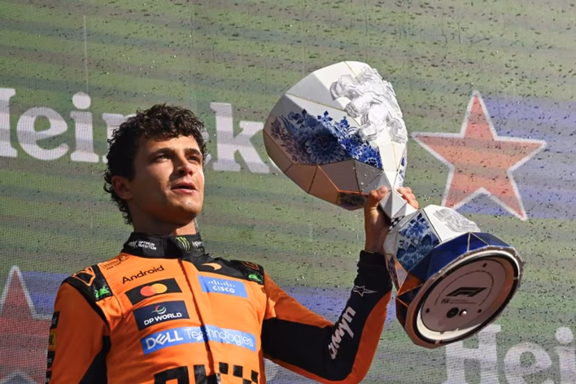 P1 McLaren's British driver Lando Norris celebrates with the trophy on the podium after the Formula One Dutch Grand Prix at The Circuit Zandvoort, western Netherlands, on August 23, 2026. JOHN THYS / AFP