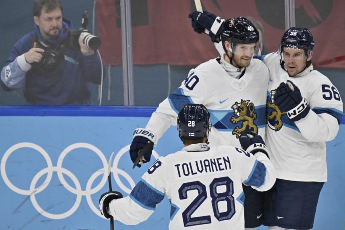 Finland's #40 Joel Armia, Finland's #56 Erik Haula and Finland's #28 Eeli Tolvanen celebrate after their team's second goal during the men's bronze medal ice hockey match between Slovakia and Finland at the Milano Santagiulia Ice Hockey Arena during the Milano Cortina 2026 Winter Olympic Games in Milan, on February 21, 2026. Alexander NEMENOV / AFP