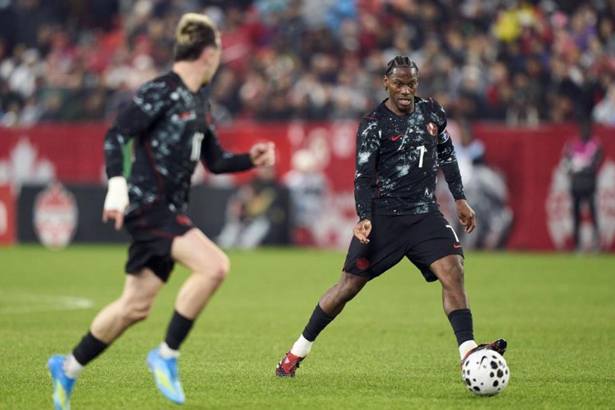 Canada's forward #07 Jonathan David (R) controls the ball during a friendly football match between Canada and Tunisia at BMO Field in Toronto, Canada, on March 31, 2026. Geoff Robins / AFP