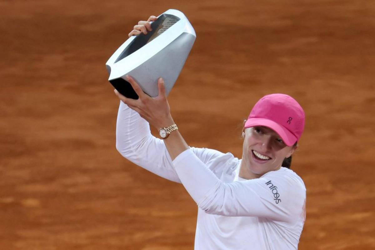 Poland's Iga Swiatek holds her trophy after beating Belarus' Aryna Sabalenka during the 2024 WTA Tour Madrid Open tournament final tennis match at Caja Magica in Madrid on May 4, 2024. Thomas COEX / AFP