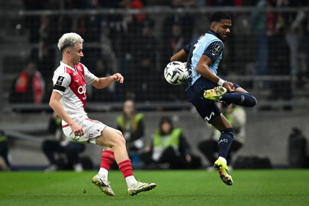 Le Havre's Hungarian defender #07 Loic Nego (R) controls the ball in front of Monaco's Russian midfielder #10 Aleksandr Golovin (L) during the French L1 football match between Le Havre AC and AS Monaco at the Oceane Stadium in Le Havre, north-western France, on January 24, 2026. Lou BENOIST / AFP