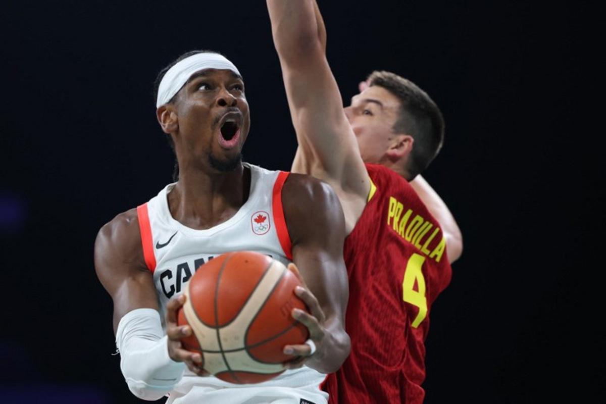 Canada's #02 Shai Gilgeous-Alexander (L) challenges Spain's #04 Jaime Pradilla in the men's preliminary round group A basketball match between Canada and Spain during the Paris 2024 Olympic Games at the Pierre-Mauroy stadium in Villeneuve-d'Ascq, northern France, on August 2, 2024. Thomas COEX / AFP