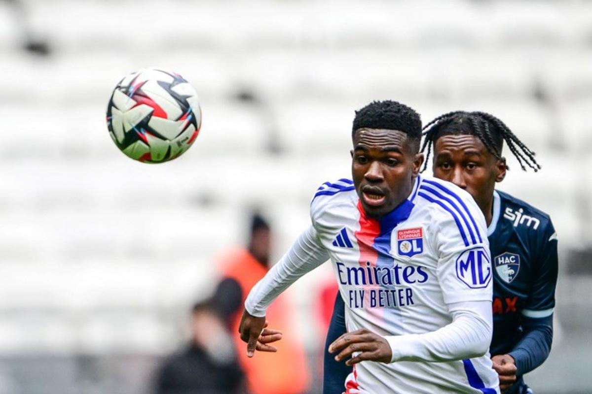 Lyon's Ghanaian forward #37 Ernest Nuamah (L) fights for the ball with Le Havre's French defender #32 Timothee Pembele during the French L1 football match between Olympique Lyonnais (OL) and Le Havre AC at the Groupama Stadium in Decines-Charpieu, central-eastern France, on March 16, 2025. OLIVIER CHASSIGNOLE / AFP