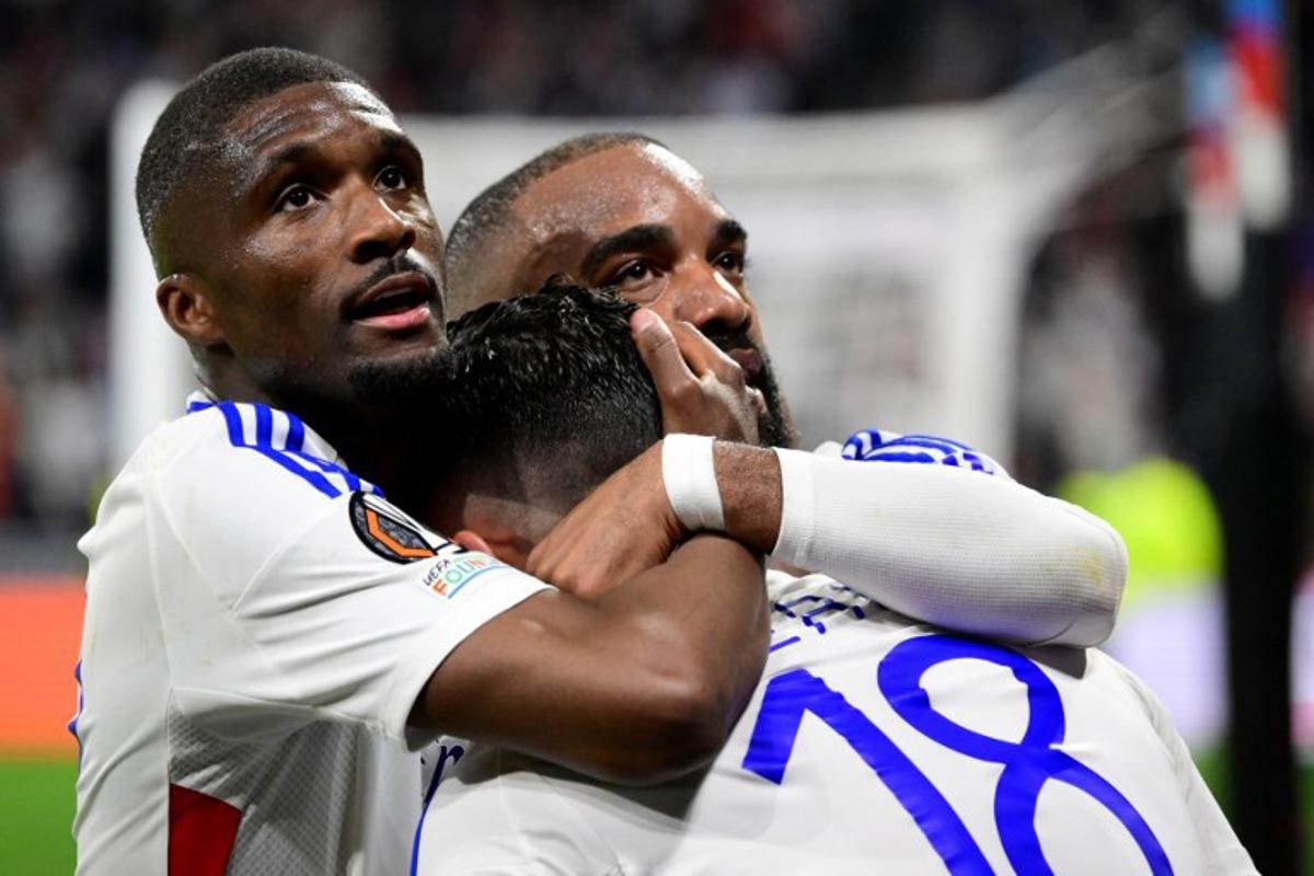 Lyon's French midfielder #18 Rayan Cherki celebrates, with Lyon's Angolan defender #22 Clinton Mata (L) and Lyon's French forward #10 Alexandre Lacazette, scoring his team's second goal during the UEFA Europa League Quarter final first leg football match between Olympique Lyonnais (OL) and Manchester United at the Parc Olympique Lyonnais Groupama stadium in Decines-Charpieu, central-eastern France, on April 10, 2025. Olivier CHASSIGNOLE / AFP