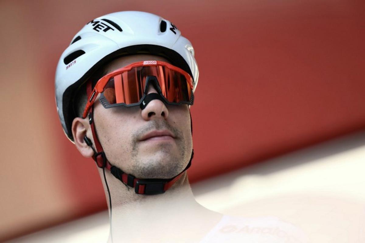 Team UAE's Portuguese rider Joao Almeida is presented on stage before the start of the Vuelta a Espana, a 183 km race between Torino - Reggia di Venaria and Novara, in Italy's Piemonte region, on August 23, 2025. Marco BERTORELLO / AFP