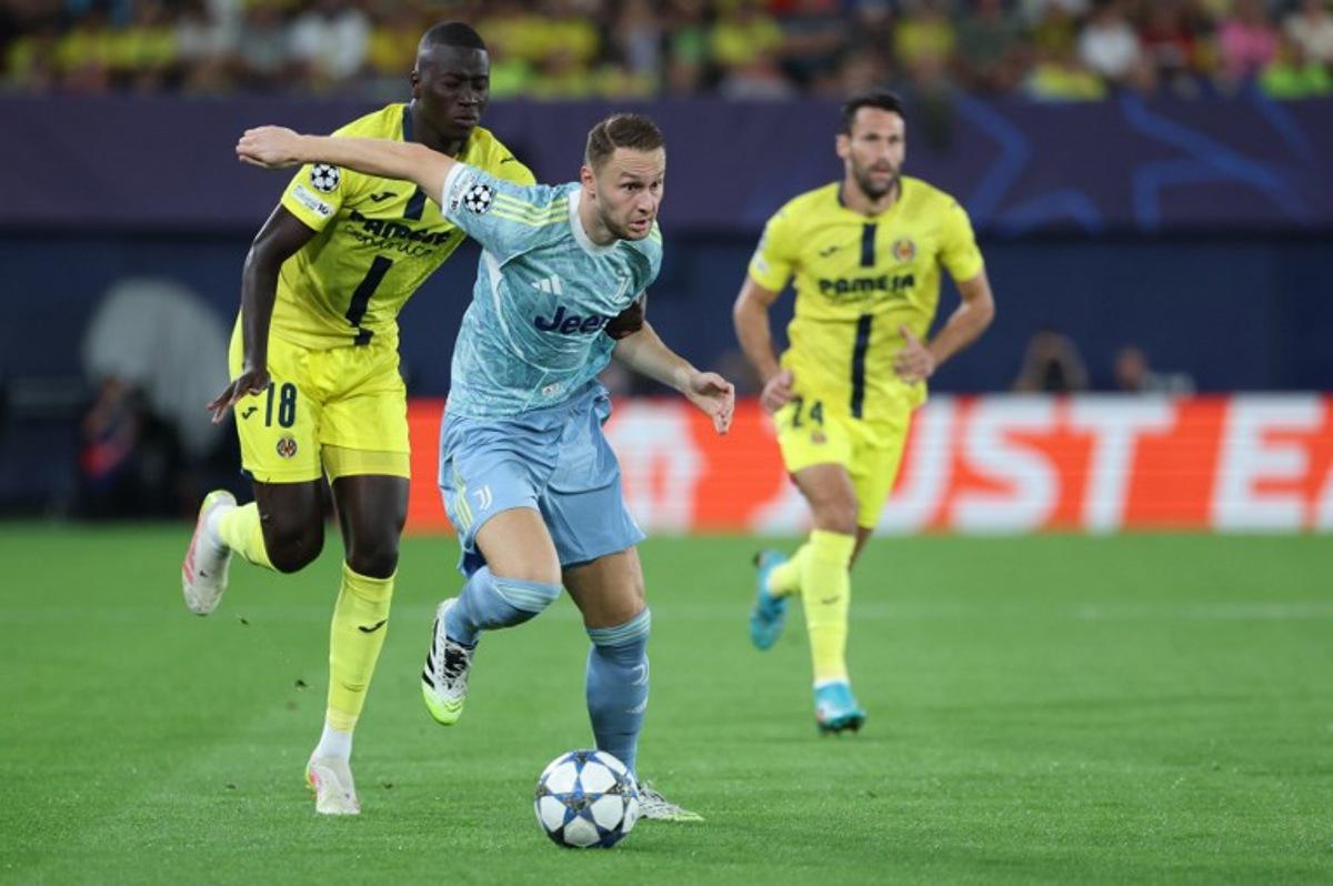 Villarreal's Senegalese midfielder #18 Pape Gueye challenges Juventus' Dutch midfielder #08 Teun Koopmeiners during the UEFA Champions League, league phase day 2 football match between Villarreal CF and Juventus at La Ceramica stadium in Vila-real on October 1, 2025. Thomas COEX / AFP