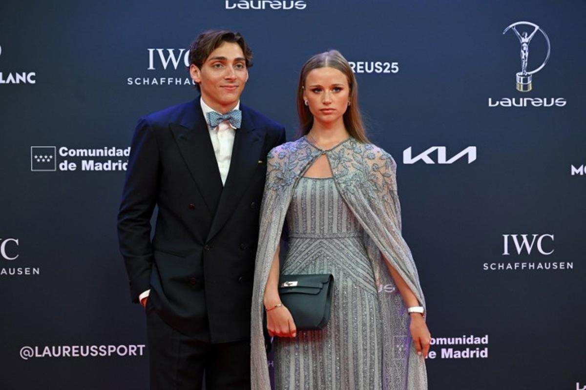 Swedish pole vaulter Armand Duplantis (L) and his partner pose on the Red Carpet ahead of the 26th Laureus World Sports Awards gala in Madrid on April 21, 2025. JAVIER SORIANO / AFP