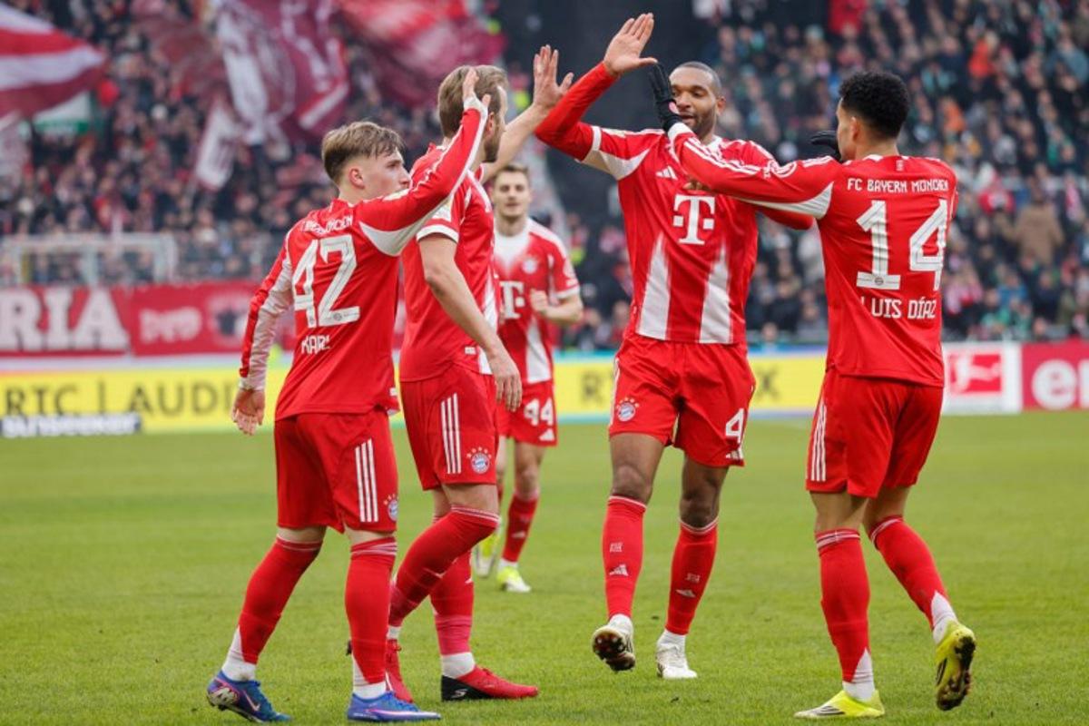 Bayern Munich's English forward #09 Harry Kane (2nd L) celebrates scoring the 0-2 goal with his teammates during the German first division Bundesliga football match between SV Werder Bremen and FC Bayern Munich in Bremen, northern Germany February 14, 2026. Focke Strangmann / AFP