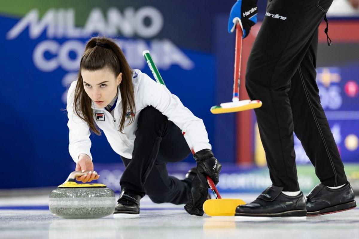 Italy's Stefania Constantini (L) competes in the curling mixed doubles round robin between Sweden and Italy during the Milano Cortina 2026 Winter Olympic Games at the Cortina Curling Olympic Stadium in Cortina d'Ampezzo on February 7, 2026. Odd ANDERSEN / AFP