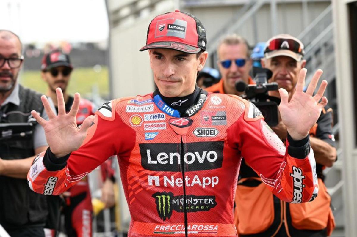 Ducati Lenovo Team's Spanish MotoGP rider Marc Marquez greets fans at the paddock before the warm-up session of the MotoGP Japanese Grand Prix at the Mobility Resort Motegi in Motegi, Tochigi prefecture on September 28, 2025. Toshifumi KITAMURA / AFP