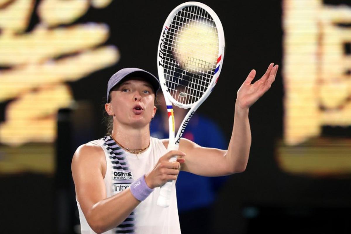 Poland's Iga Swiatek celebrates victory over China's Yuan Yue after their women's singles match on day two of the Australian Open tennis tournament in Melbourne on January 19, 2026. DAVID GRAY / AFP
