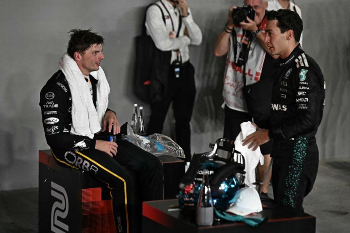 First-placed Mercedes' British driver George Russell (R) and second-placed Red Bull Racing's Dutch driver Max Verstappen react after the Formula One Singapore Grand Prix night race at the Marina Bay Street Circuit in Singapore on October 5, 2025. Lillian SUWANRUMPHA / AFP