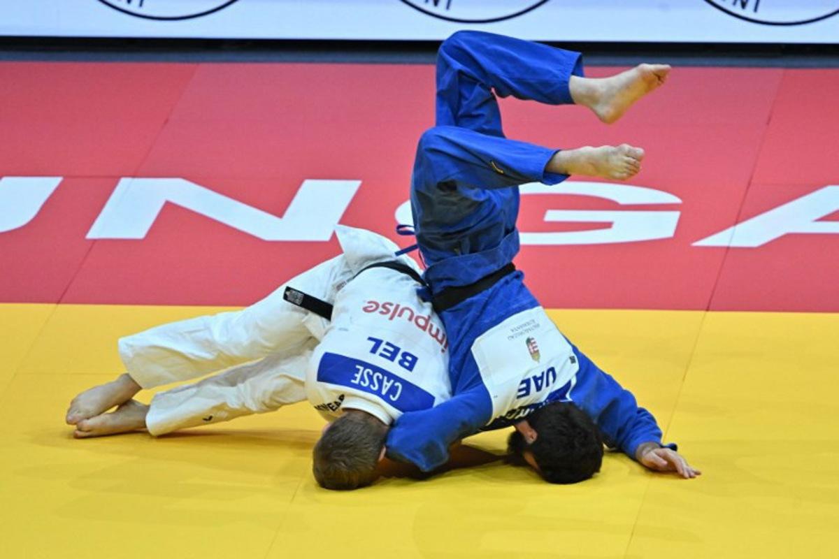 Belgium's Matthias Casse competes against United Arab Emirates' Gadzhimurad Omarov (blue) in the men's -81kg qualification round of the Judo World Championships at Papp Laszlo Arena in Budapest, Hungary, on June 16, 2025. Attila KISBENEDEK / AFP