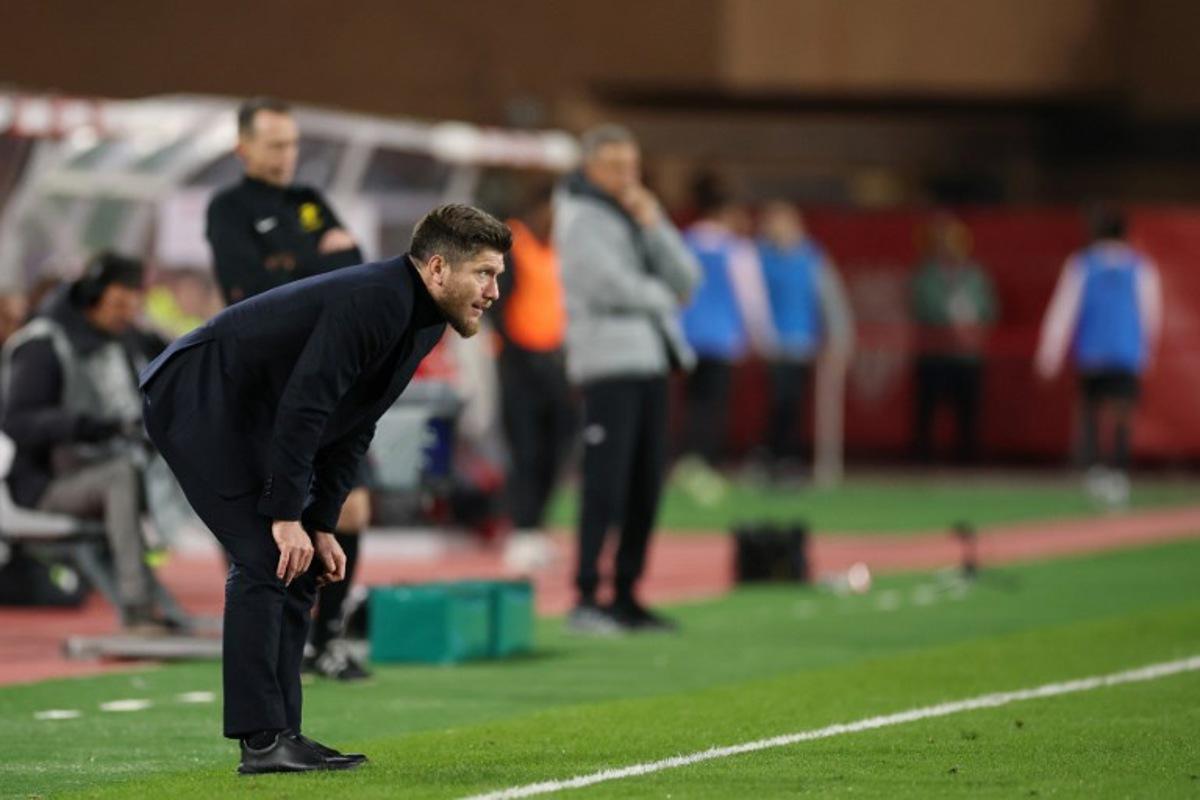 Monaco's Belgian head coach Sebastien Pocognoli looks on from the sideline during the French L1 football match between AS Monaco and Paris Saint-Germain (PSG) at the Stade Louis II in the Principality of Monaco on November 29, 2025. Valery HACHE / AFP