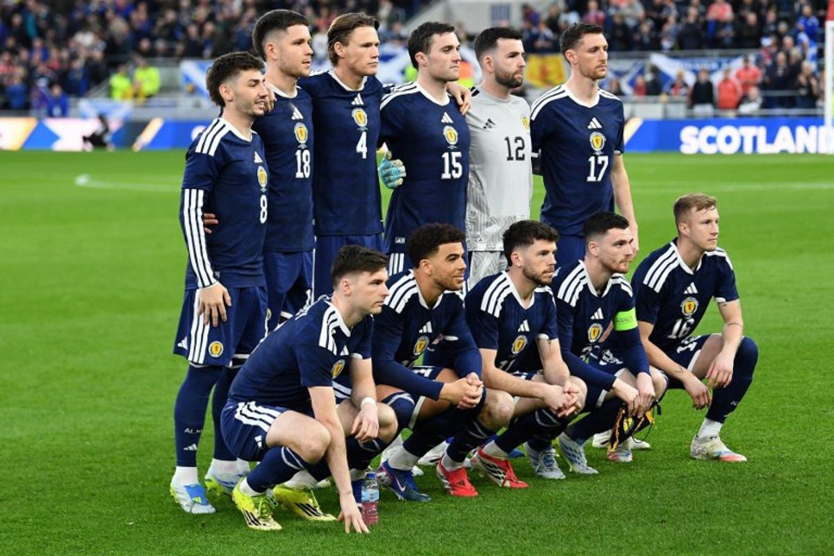 (Back row L-R) Scotland's midfielder #08 Billy Gilmour, Scotland's striker #18 George Hirst, Scotland's midfielder #04 Scott McTominay, Scotland's defender #15 John Souttar, Scotland's goalkeeper #12 Liam Kelly and Scotland's defender Dominic Hyam, (Front row L-R) Scotland's defender #06 Kieran Tierney, Scotland's forward #10 Che Adams, Scotland's forward #11 Ryan Christie, Scotland's defender #03 Andrew Robertson and Scotland's midfielder #16 Ross McCrorie pose for a team photo ahead of the friendly international football match between Scotland and Ivory Coast at the Hill Dickinson Stadium in Liverpool, north west England on March 31, 2026. PETER POWELL / AFP