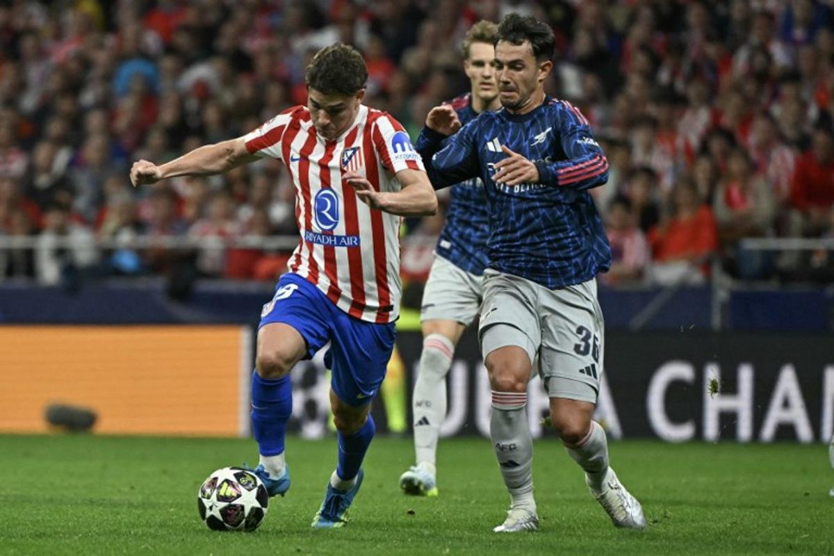 Atletico Madrid's Argentine forward #19 Julian Alvarez (L) vies for the ball with Arsenal's Spanish defender #36 Martin Zubimendi during the UEFA Champions League semi-final first leg football match between Club Atletico de Madrid and Arsenal at the Metropolitano stadium in Madrid on April 29, 2026. Javier SORIANO / AFP