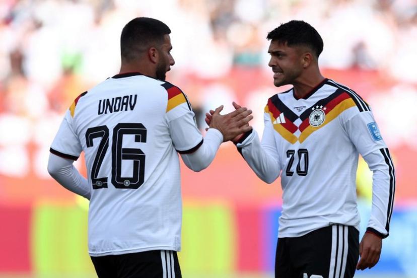Germany's forward #26 Deniz Undav (L) is congratulated by Germany's midfielder #20 Nadiem Amiri after scoring his team's first goal during the 2026 World Cup Group E football match between Germany and Ivory Coast at the Toronto Stadium in Toronto on June 20, 2026. Cole Burston / AFP