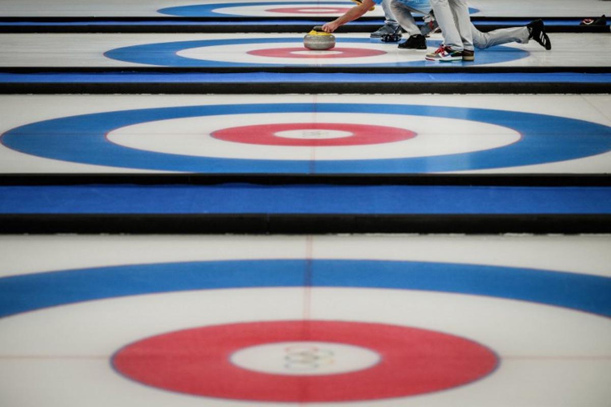 USA's John Shuster curls the stone during the men's bronze medal game of the Beijing 2022 Winter Olympic Games curling competition between Canada and USA at the National Aquatics Centre in Beijing on February 18, 2022. Jeff PACHOUD / AFP