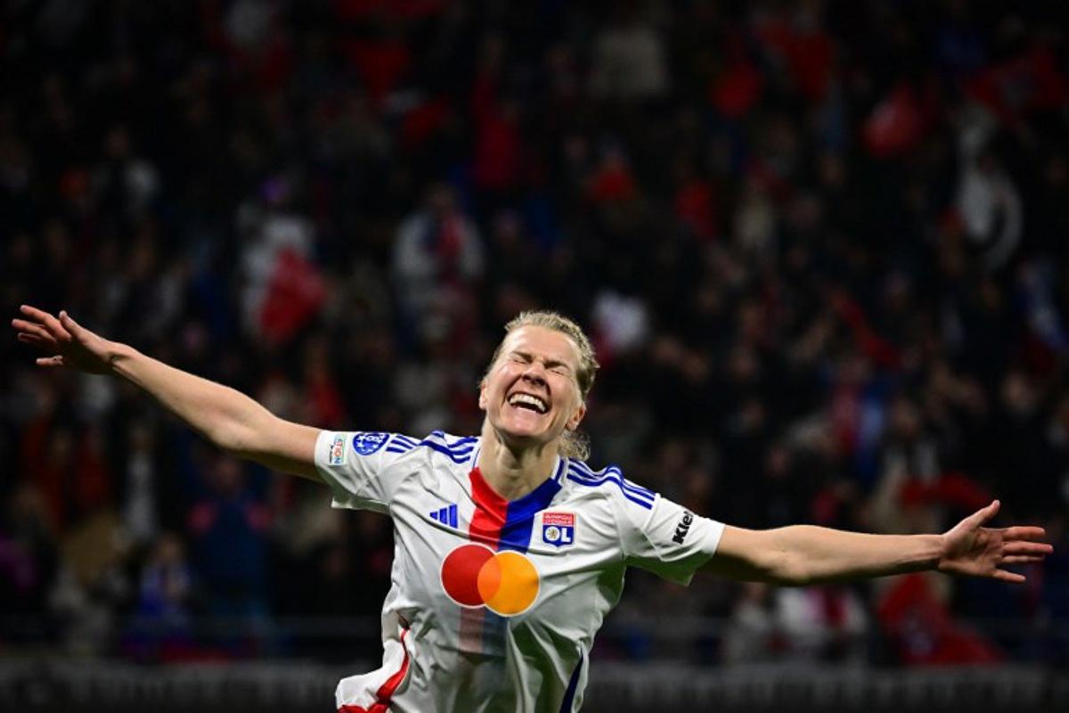 Lyon's Norwegian forward #14 Ada Hegerberg celebrates after scoring Lyon's fourth goal during the UEFA Women's Champions League quarter final second leg football match between Olympique Lyonnais (FRA) and FC Bayern Munich (GER) at the OL Stadium in Decines-Charpieu, central-eastern France, on March 26, 2025. OLIVIER CHASSIGNOLE / AFP