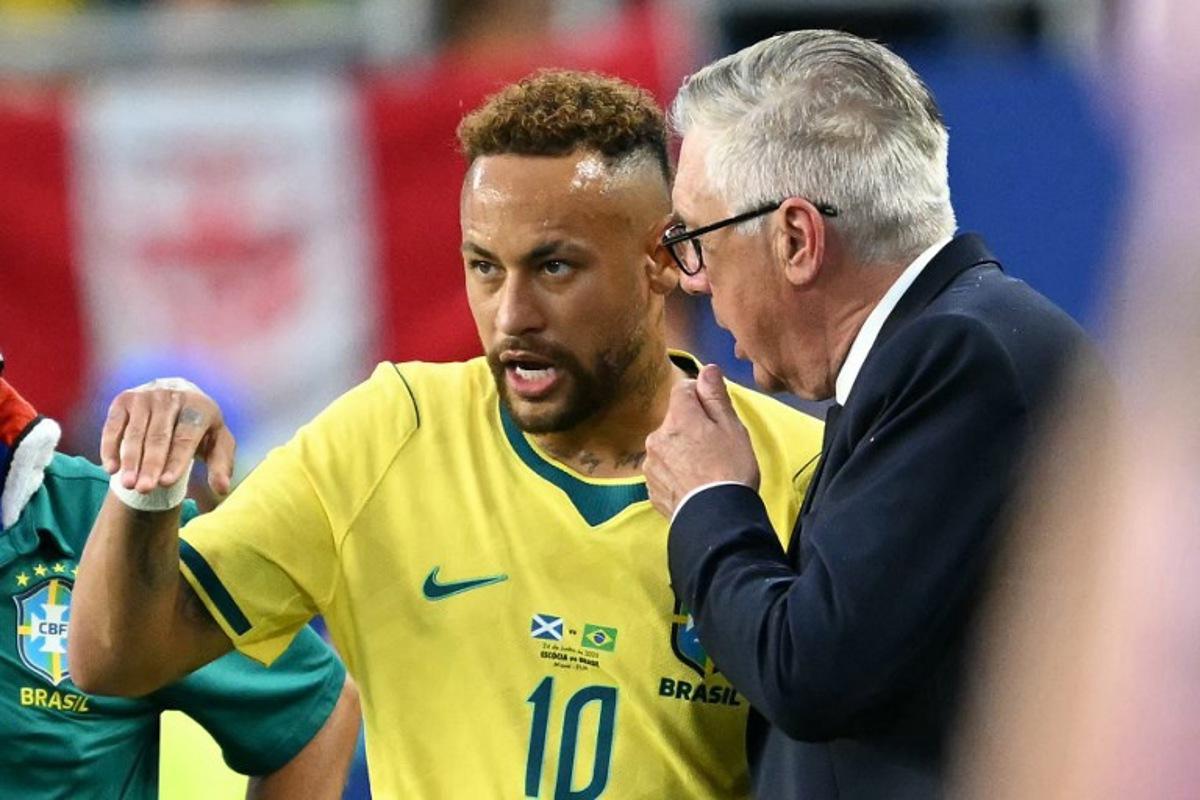 Brazil's Italian head coach Carlo Ancelotti talks to his forward #10 Neymar during the 2026 World Cup Group C football match between Scotland and Brazil at the Miami Stadium in Miami Gardens on June 24, 2026. CHANDAN KHANNA / AFP