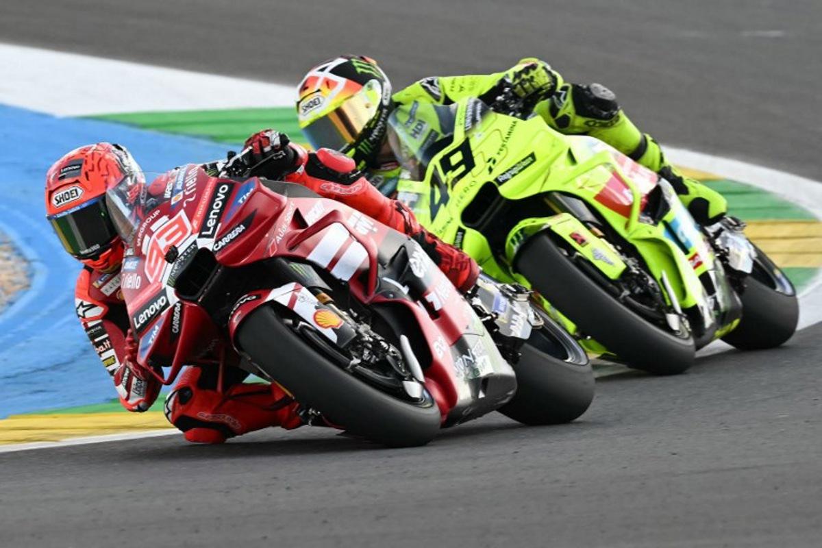 Ducati Lenovo's Spanish rider Marc Marquez (L) and Pertamina Enduro VR46 Racing Team's Italian rider Fabio Di Giannantonio compete during the MotoGP sprint of the Grand Prix of Brazil at the Ayrton Senna International racetrack in Goiania, state of Goias, Brazil, on March 21, 2026. EVARISTO SA / AFP