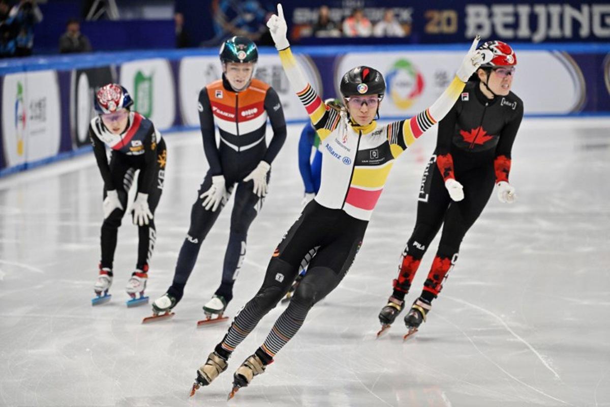 Belgium's Hanne Desmet (C) celebrates her victory in the women's 1000 meters final at the ISU World Short Track Championships in Beijing on March 15, 2025. ADEK BERRY / AFP