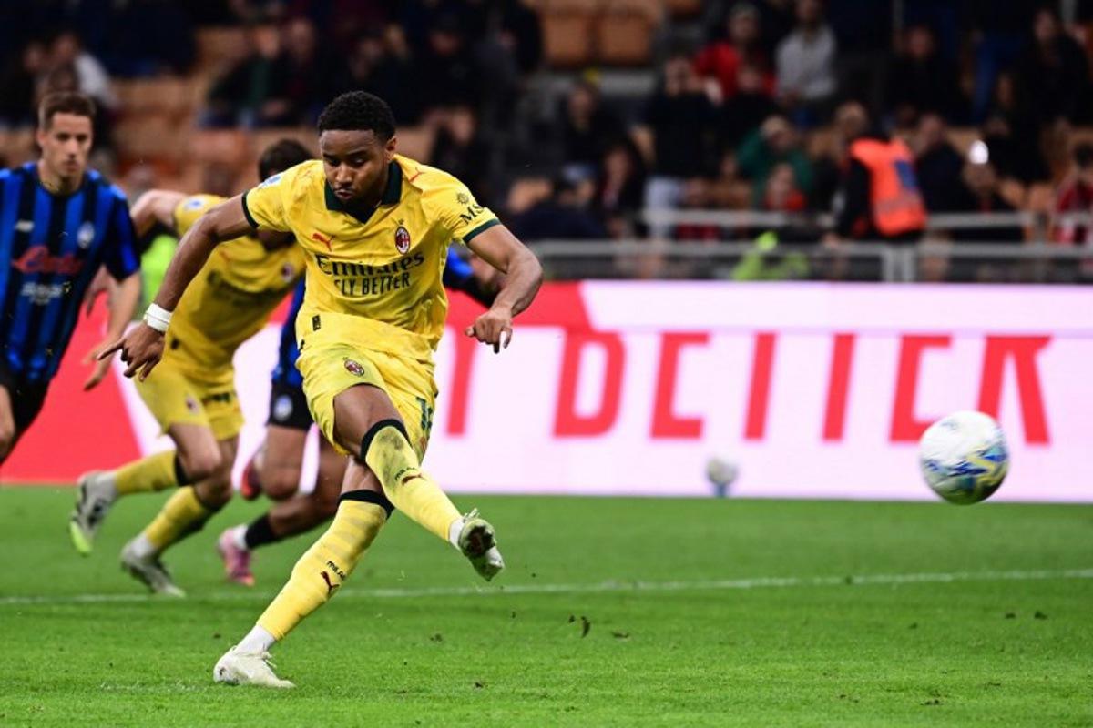 AC Milan's French forward #18 Christopher Nkunku scores a penalty kick during the Italian Serie A football match between AC Milan and Atalanta Bergamo at San Siro Stadium in Milan on May 10, 2026. Piero CRUCIATTI / AFP