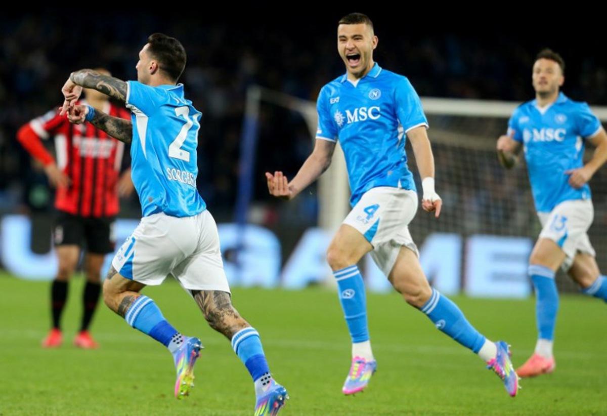Napoli's Italian forward #21 Matteo Politano (L) celebrates after scoring a goal with teammate Napoli's Italian defender #4 Alessandro Buongiorno (R) during the Italian Serie A football match between Napoli and AC Milan at the Stadio Diego Armando Maradona in Naples, on March 30, 2025. CARLO HERMANN / AFP