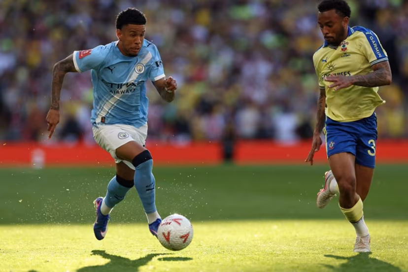 Manchester City's Brazilian midfielder #26 Savinho (L) runs at Southampton's Brazilian defender #34 Welington (R) during the English FA Cup semi final football match between Manchester City and Southampton at Wembley stadium in London, on April 25, 2026. Adrian Dennis / AFP