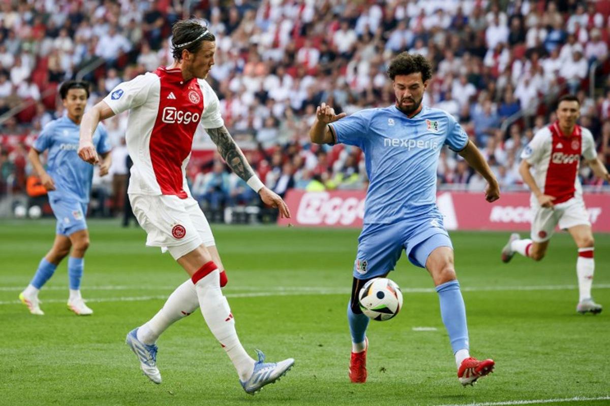 Ajax's Dutch forward #19 Wout Weghorst (L) fights for the ball with NEC's Dutch defender #03 Philippe Sandler during the Dutch Eredivisie football match between Ajax Amsterdam and and NEC Nijmegen at the Johan Cruijff ArenA in Amsterdam on May 11, 2025. Koen van Weel / ANP / AFP
