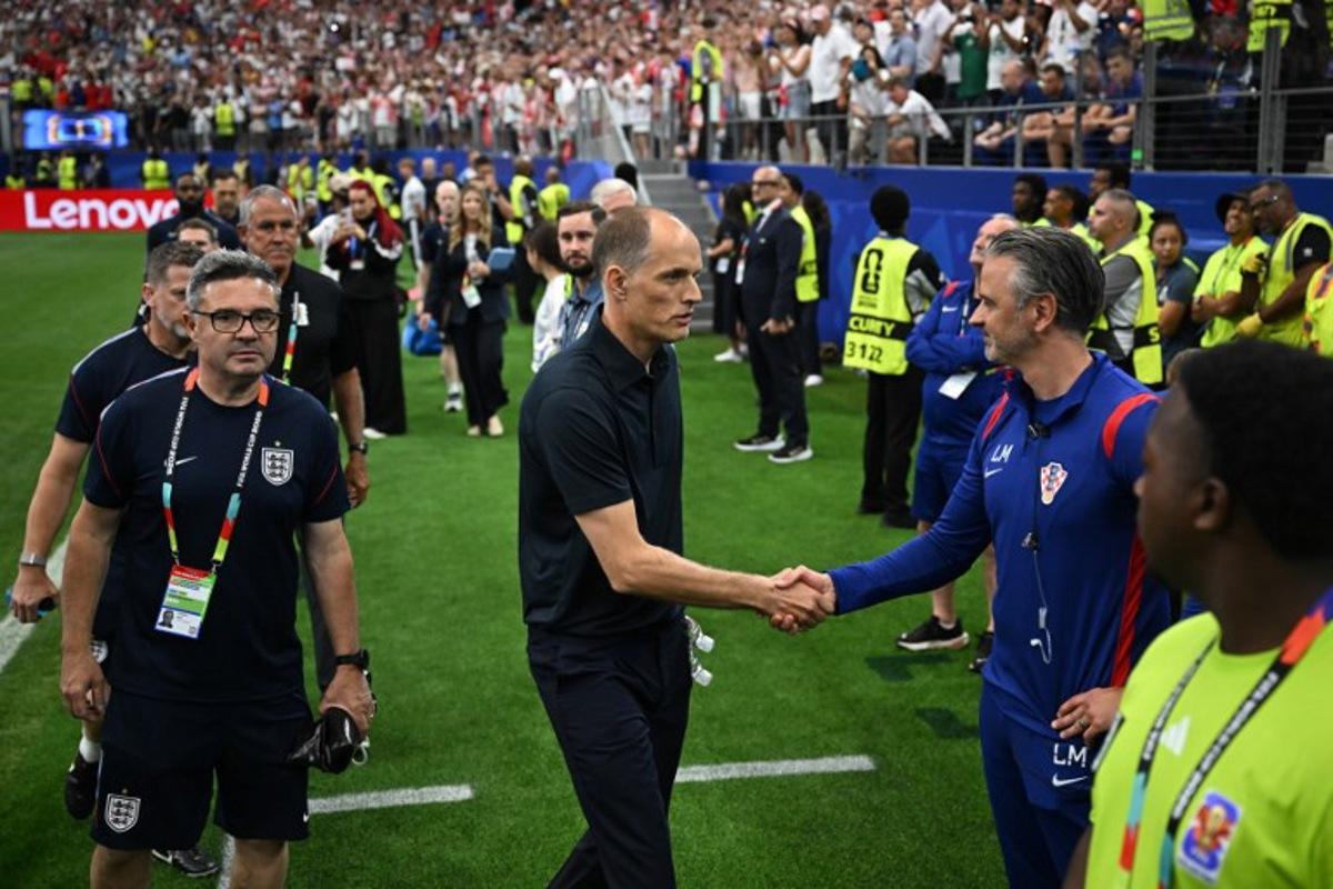 England's German head coach Thomas Tuchel (C) shakes hands with a Croatia staff member as he arrives for the 2026 World Cup Group L football match between England and Croatia at the Dallas Stadium in Arlington on June 17, 2026. Paul ELLIS / AFP