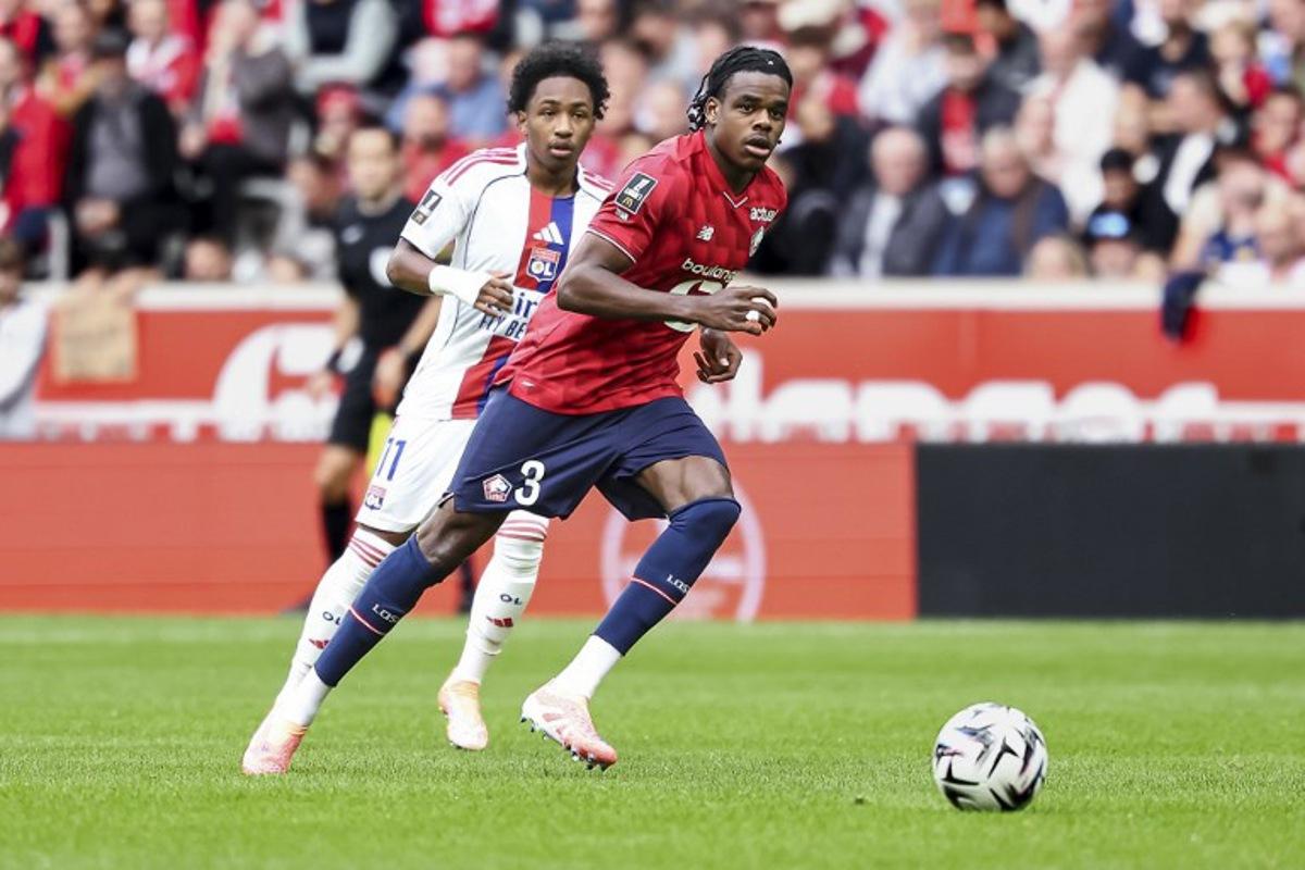 Lille's Belgian defender #03 Nathan Ngoy runs with the ball during the French L1 football match between Lille LOSC and Olympique Lyonnais (OL) at the Stade Pierre-Mauroy in Villeneuve-d'Ascq, northern France, on September 28, 2025. Sameer Al-DOUMY / AFP